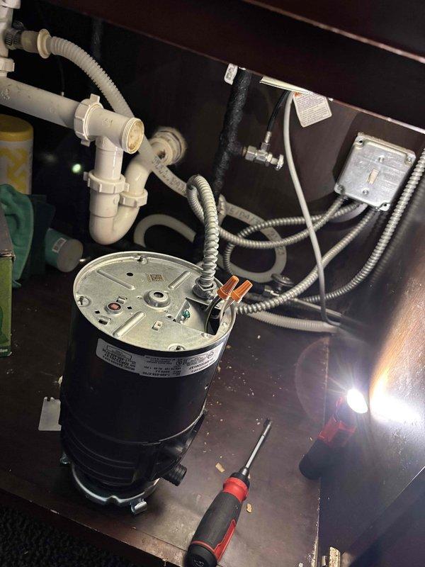Responded to a garbage disposal replacement request. Upon arrival, accessed the under-sink cabinet and disconnected the existing disposal unit from the electrical supply and drain plumbing. Removed the old disposal from the sink mounting assembly. Installed new garbage disposal unit, securing it to the existing sink flange with proper mounting hardware. Connected the discharge tube to the existing P-trap and drain assembly using appropriate PVC fittings. Verified electrical connections were secure with wire nuts and confirmed GFCI outlet protection was functioning properly. Tested the new disposal for proper operation, checking for leaks at all connection points and ensuring smooth motor function. Left work area clean and operational.