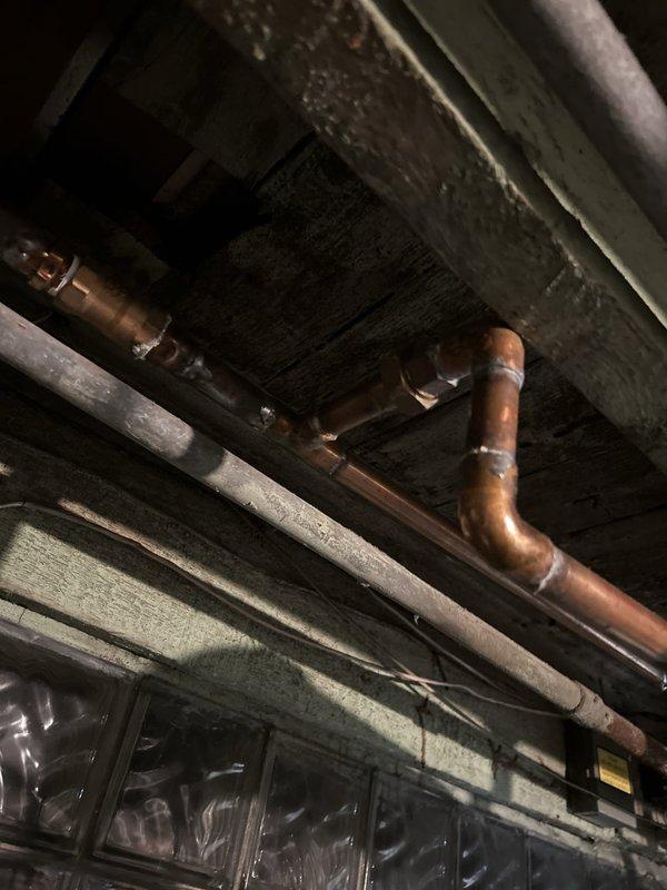 Conducted plumbing estimate for two issues: a shower mixing valve that fails to completely shut off water flow when the handle is fully closed, and a leaking gas valve at the stove connection that began leaking following a gas line replacement performed two months prior. Documented both fixtures with photographs for estimate preparation.
