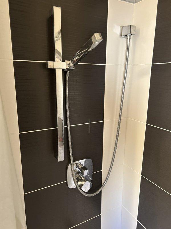 Conducted plumbing estimate for two issues: a shower mixing valve that fails to completely shut off water flow when the handle is fully closed, and a leaking gas valve at the stove connection that began leaking following a gas line replacement performed two months prior. Documented both fixtures with photographs for estimate preparation.