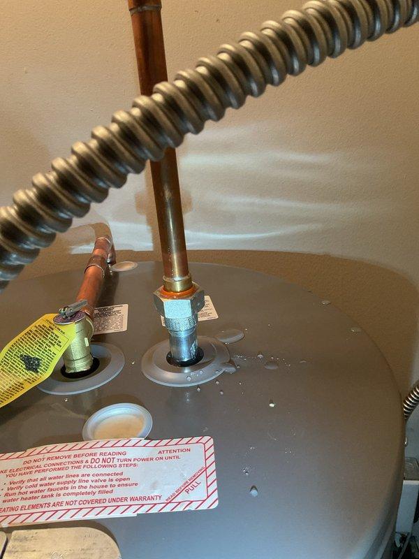 Responded to service call for non-functional water heater and performed on-site evaluation to provide estimate. Upon inspection, documented existing water heater installation showing copper supply line connections at unit top with visible moisture present on tank surface. Observed significant blue-green corrosion on copper piping indicating advanced oxidation and potential leak points in the plumbing system. Photographed plumbing configuration including supply connections, shut-off valves, and pipe routing for estimate documentation. Customer advised that no immediate repair work was requested at this time, estimate only to be provided for water heater replacement and associated plumbing corrections.