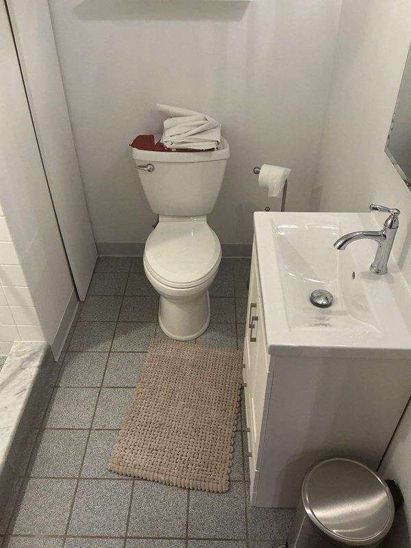 Responded to service call for freestanding oval bathtub requiring stabilization. Upon inspection, identified bathtub movement and insufficient anchoring to subfloor. Secured bathtub in place by installing proper mounting hardware and ensuring level positioning on marble-patterned tile flooring. Verified structural integrity, tested for movement, and confirmed stable installation. Bathtub now properly anchored with no shifting or rocking detected.
