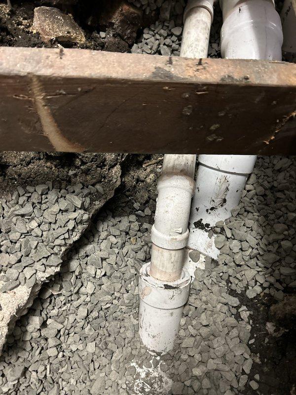 Accessed crawl space to assess and address plumbing system concerns beneath residential structure. Inspected existing PVC drainage lines running through foundation area, noting moisture exposure and age-related deterioration of supporting wooden joists. Completed repair work requiring floor access, with drainage system components serviced and bucket collection system positioned for ongoing monitoring. Financing arrangements established for customer, with follow-up scheduling coordinated for project completion.