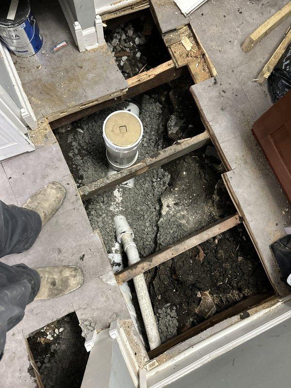 Accessed crawl space to assess and address plumbing system concerns beneath residential structure. Inspected existing PVC drainage lines running through foundation area, noting moisture exposure and age-related deterioration of supporting wooden joists. Completed repair work requiring floor access, with drainage system components serviced and bucket collection system positioned for ongoing monitoring. Financing arrangements established for customer, with follow-up scheduling coordinated for project completion.