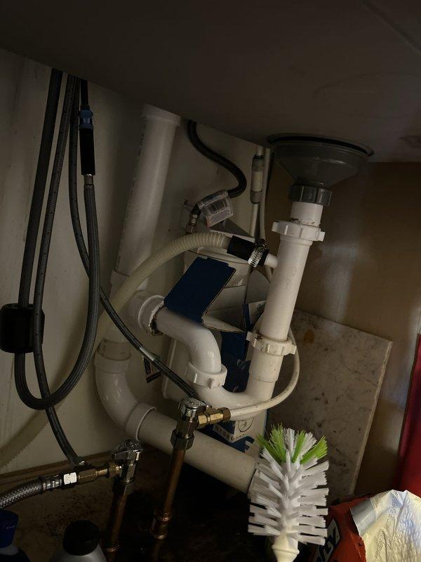 Responded to kitchen sink drain leak. Upon inspection, identified compromised slip-joint connections in the PVC P-trap assembly beneath the sink. Disassembled drain system, cleaned all mating surfaces, and reinstalled P-trap with new washers and proper alignment. Tightened all compression fittings to manufacturer specifications. Tested system under full water flow to verify leak elimination. All plumbing components now functioning properly with no active leaks detected.