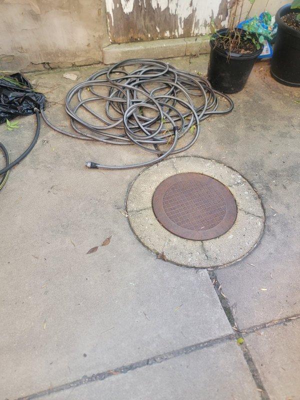 Responded to bottom unit condo experiencing bubbling toilets and slow drainage in tubs and toilets. Performed main drain cleanout investigation and cleared blockage from exterior cleanout access point using mechanical auger equipment. Verified proper drainage flow restored to all fixtures. Additionally diagnosed and addressed water hammer issue causing pipe banging in walls during tub filling by inspecting water supply lines and pressure conditions.