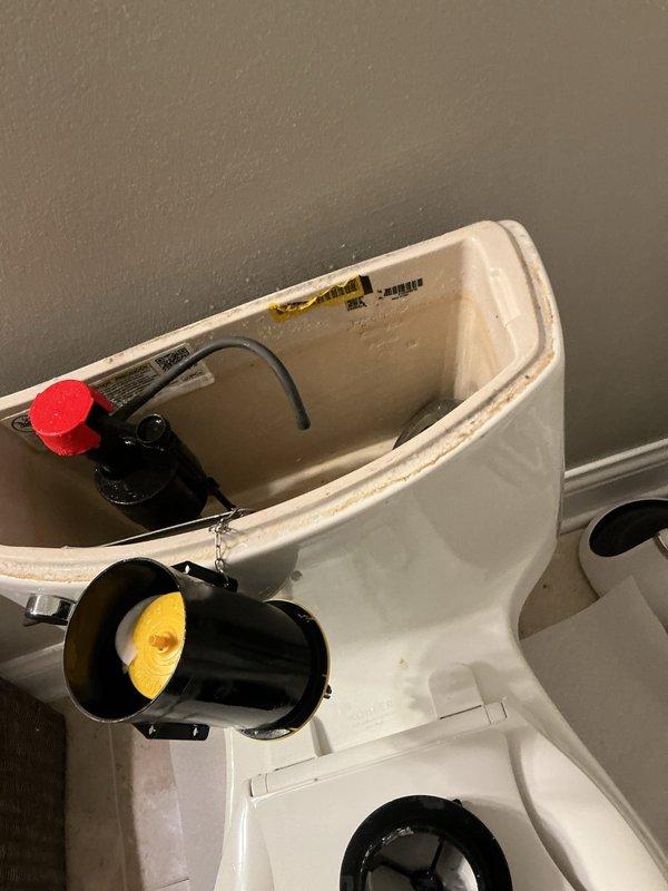 Responded to overflow issue at toilet tank where water was escaping through the flush handle mechanism. Upon inspection, determined that the water level in the tank was set too high, causing overflow through the handle assembly. Adjusted the fill valve to lower the maximum water level in the tank, preventing overflow while maintaining proper flush function. Technician will return with replacement part for complete repair.