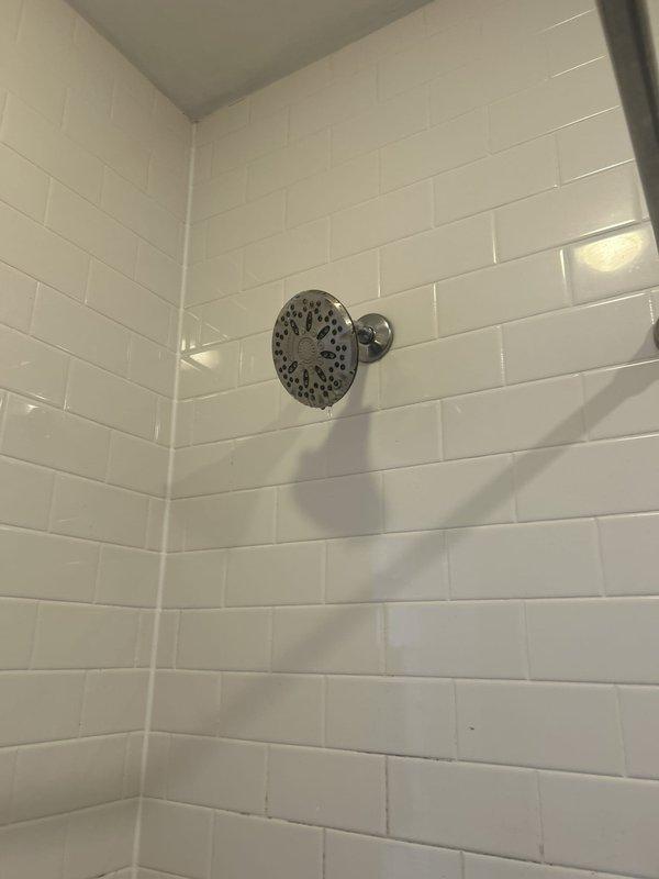 Completed shower valve and tub spout installation in bathroom with white subway tile surround. Installed chrome shower control valve with single lever handle and matching chrome tub spout, ensuring proper alignment and secure mounting to wall. Verified all connections for proper water flow and tested fixtures for leaks prior to completion.