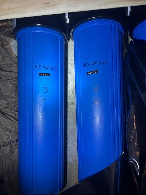Completed annual maintenance on whole house 3-stage water filtration system by replacing all Waterdrop filter cartridges in the blue housings mounted in the utility area. Documented filter replacement with updated installation dates marked on each housing (November), ensuring proper flow direction indicators were noted. System tested and verified operational with no leaks detected at housing seals or plumbing connections.