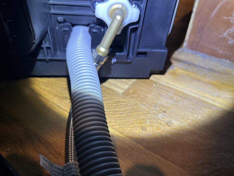 Responded to active water leak originating from dishwasher supply line connection in kitchen. Upon inspection, identified leak at brass fitting where corrugated flexible hose connects to dishwasher inlet valve, with visible mineral buildup and moisture present at connection point. Shut off water supply to appliance, disconnected faulty corrugated hose, and replaced with new braided stainless steel supply line. Secured all connections with proper torque specifications, restored water supply, and tested dishwasher through complete fill cycle to verify leak was eliminated. Cleaned work area and confirmed no water damage to surrounding hardwood flooring. System returned to normal operation with no further issues detected.