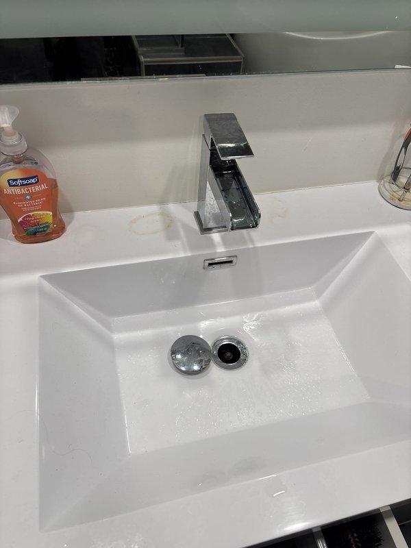 Responded to service call for loss of hot water at shower while other fixtures maintained proper hot water supply. Performed comprehensive plumbing evaluation to diagnose isolated hot water loss at shower fixture. Inspected shower valve assembly and related components to identify potential cartridge failure or internal valve malfunction causing hot water delivery issue. Evaluated multiple bathroom faucets and showerheads throughout the property as requested, documenting conditions and identifying fixtures requiring attention. Removed and inspected sink drain assemblies to assess functionality and condition. Identified corroded piping and valve connections showing significant deterioration, rust buildup, and water staining on surrounding surfaces indicating long-term moisture exposure. Documented all findings with photographic evidence of corroded components and fixtures requiring service. Provided technical assessment of shower valve system and discussed repair versus replacement optio