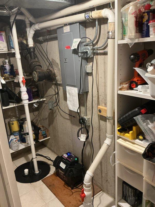 Responded to warranty call for recently installed sump pump displaying red alarm light indicator. Upon inspection, verified sump pump installation and electrical connections in basement utility area, documented existing plumbing configuration including PVC discharge piping with proper valve placement, and examined system components to diagnose alarm condition. Confirmed pump operation, checked float switch functionality, and reset alarm system to restore normal operating status.