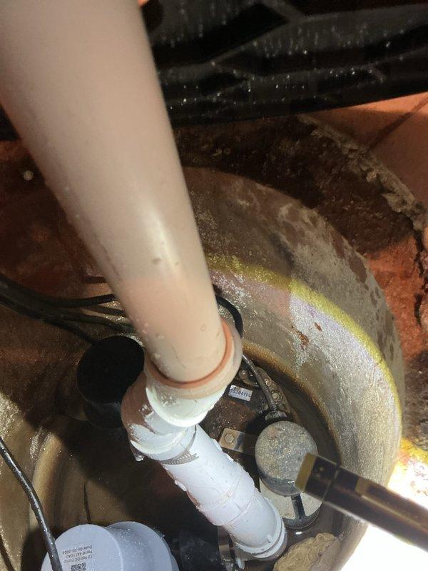 Responded to warranty call for recently installed sump pump displaying red alarm light indicator. Upon inspection, verified sump pump installation and electrical connections in basement utility area, documented existing plumbing configuration including PVC discharge piping with proper valve placement, and examined system components to diagnose alarm condition. Confirmed pump operation, checked float switch functionality, and reset alarm system to restore normal operating status.