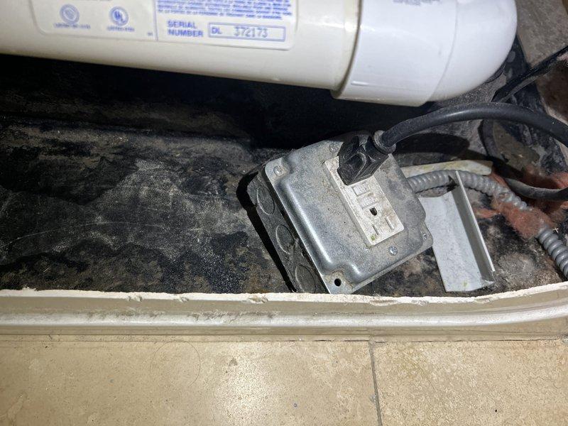 Responded to customer concern regarding potential water leak from shower or bathtub area. Accessed plumbing components through bathtub access panel to inspect water heater connections, supply lines, and drain assembly. Documented mechanical equipment condition and visible plumbing infrastructure for leak assessment and further evaluation.