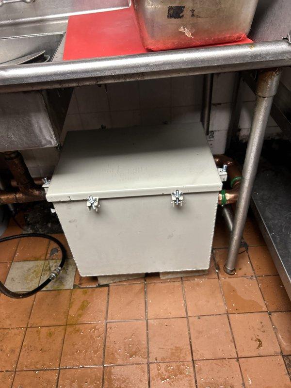Installed commercial-grade water filtration system beneath prep sink in commercial kitchen, including mounting multiple filter canisters on copper supply lines and securing all connections. Verified proper water flow through filtration system and tested for leaks at all connection points to ensure system integrity for food service operations.