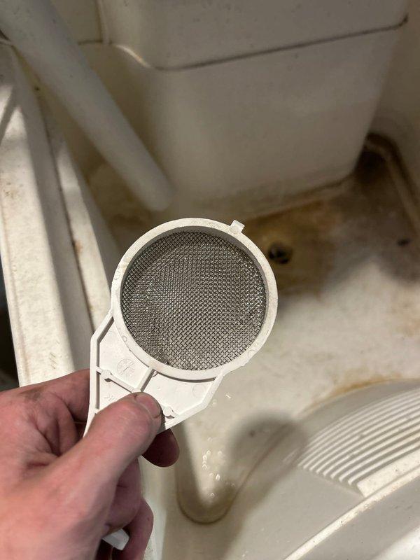Performed annual maintenance inspection on tankless water heater system. Removed and cleaned inlet water filters, which showed debris accumulation on mesh screens. Inspected both black cylindrical inlet filter and white circular strainer filter, cleared blockages, and reinstalled components to ensure optimal water flow and system performance.