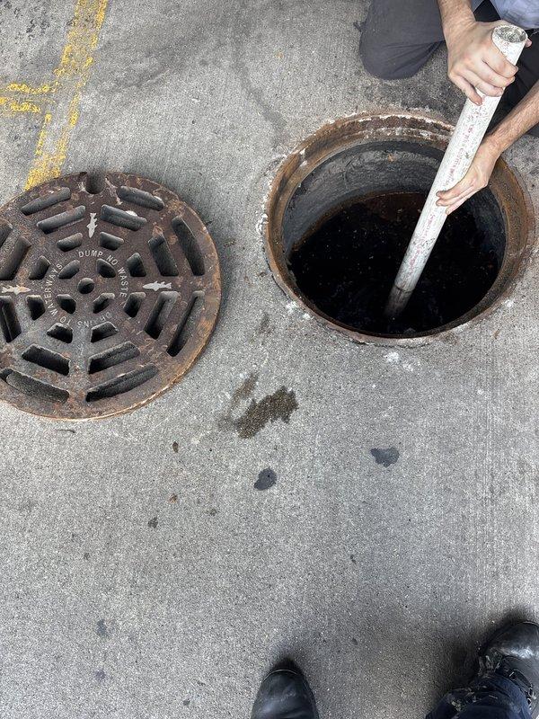 Performed outdoor storm drain inspection and cleaning service. Removed heavy cast iron grate cover to access the main drain opening and utilized specialized drain cleaning equipment to clear accumulated debris, including fibrous material and buildup obstructing the drainage system. Successfully restored proper flow and functionality to the storm sewer access point.