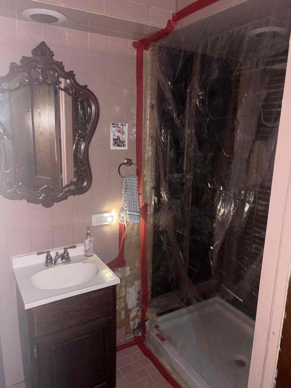 Completed comprehensive plumbing estimate for extensive repiping project in two-bathroom residential property. Documentation included assessment of existing exposed red piping in primary bathroom shower area requiring concealment and proper installation, evaluation of shower enclosure plumbing connections, and analysis of supply line routing for vanity fixtures and pedestal sink applications.