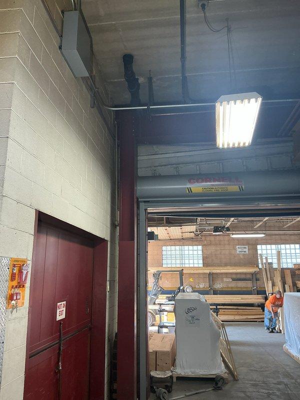 Responded to water leak location service for 6-inch drain pipe leaking from ceiling to floor in commercial facility. Documented ceiling-mounted drainage infrastructure including black insulated piping, metallic drain lines, and associated fittings in unfinished concrete ceiling space. Photographed leak source area and surrounding mechanical systems for assessment and repair planning.