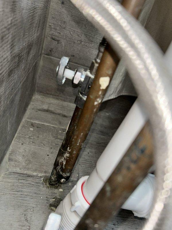 Responded to water leak originating from master bedroom en-suite shower that was causing ceiling stains in the living room below. Upon inspection, identified failed gasket seal on the shower drain assembly as the source of water intrusion. Removed existing drain components and replaced the deteriorated gasket with new sealing materials to prevent further water migration through the floor assembly. Tested the shower drain system under running water conditions to verify proper seal and confirm no active leakage. Inspected associated plumbing connections including supply lines, shut-off valves, and waste piping to ensure overall system integrity. Documented existing plumbing conditions including copper supply lines showing age-related oxidation and PVC drain assemblies. All connections were verified tight and functioning properly upon completion.