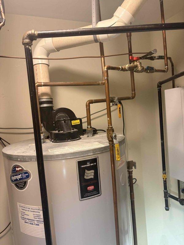 Conducted comprehensive plumbing estimation for water heater systems, evaluating both a traditional tank-style water heater and a tankless water heater installation. Documented existing plumbing configurations including copper supply lines, black iron gas piping, PVC ventilation systems, pressure relief valves, shut-off valves, circulation pumps, and associated piping connections to provide accurate assessment for potential replacement or repair options.