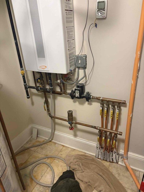 Conducted comprehensive plumbing estimation for water heater systems, evaluating both a traditional tank-style water heater and a tankless water heater installation. Documented existing plumbing configurations including copper supply lines, black iron gas piping, PVC ventilation systems, pressure relief valves, shut-off valves, circulation pumps, and associated piping connections to provide accurate assessment for potential replacement or repair options.