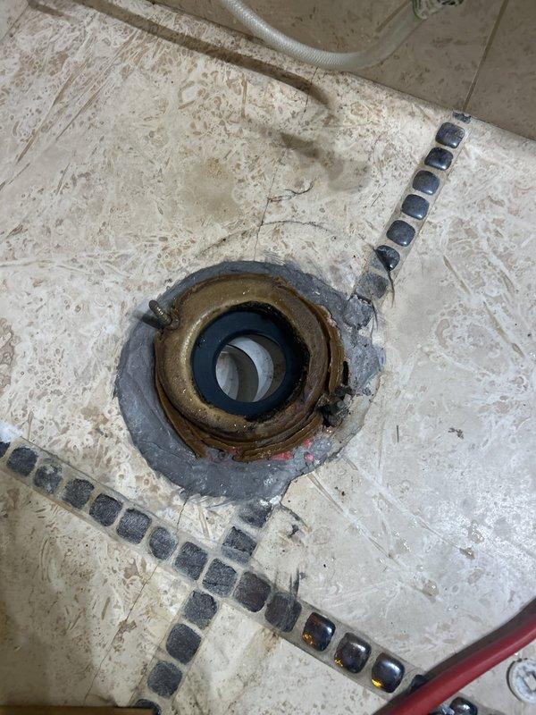 Removed the toilet and inspected the corroded brass closet flange and wax gasket, which were the source of the base leak, then reset the toilet with a new seal and addressed the tank leak. Evaluated the refrigerator ice and water supply line and the delayed hot water delivery at the fixtures, and inspected the under-sink supply stops, braided supply lines, and slip-joint drain connections, noting staining at the upper drain connection.