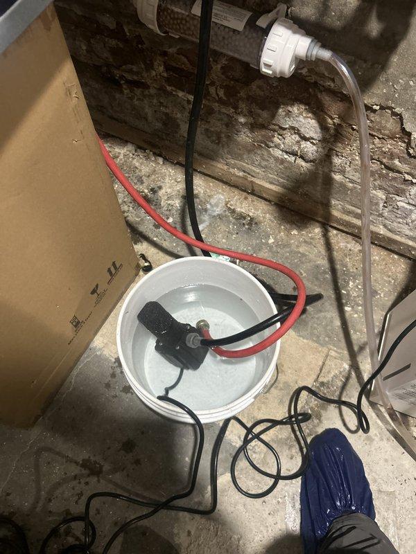 Performed annual maintenance on a Navien tankless water heater, including a full descaling flush using a submersible circulation pump, hoses, and isolation valves to remove mineral buildup from the heat exchanger. Inspected the copper piping, soldered joints, and expansion tank connections, and verified proper system operation after reconnecting.