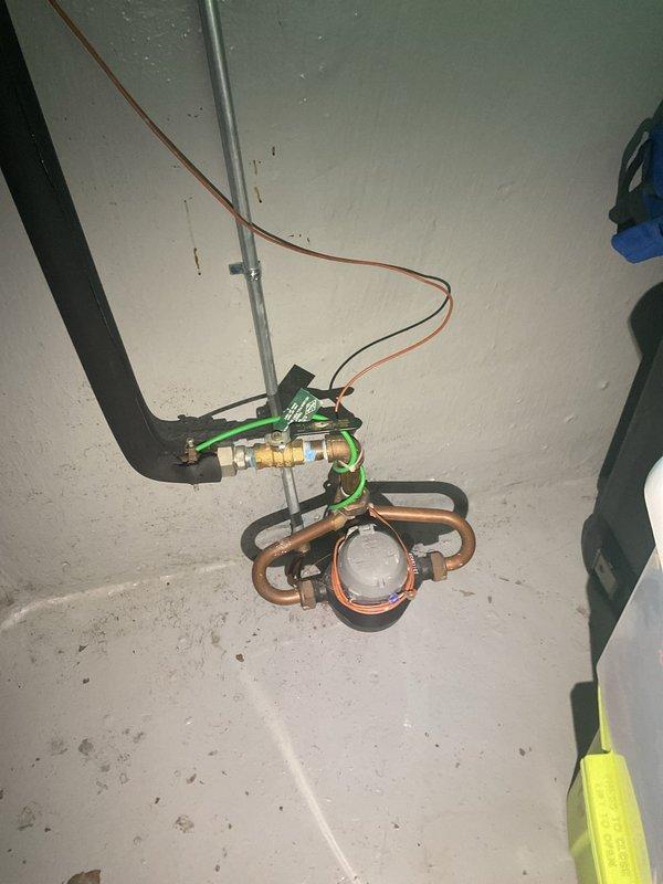 Responded to a leaking connection beneath the bathroom vanity and inspected the PVC P-trap assembly, tailpiece, slip-nut couplings, and flexible supply lines to the angle-stop valves. Isolated the source of the leak, then resealed and tightened the affected slip-joint connection, confirming a dry, watertight fitting under flow. Verified the main water meter and shutoff valve in the basement were accessible and in good working order.