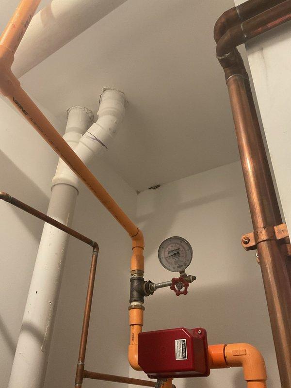Inspected the two exterior hose bibs and evaluated their condition for repair or replacement, including the valve body, threaded spout, and connections at the brick wall. Documented sealant buildup and deterioration around the base of the spigot, and checked the supply piping and shutoff components in the mechanical room to confirm the system's operating condition and isolation points.