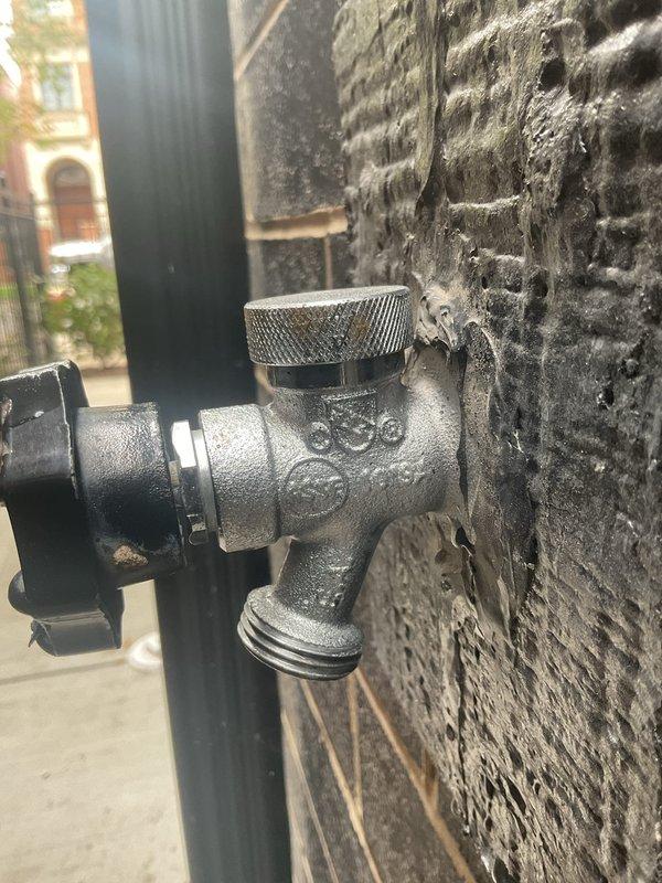 Inspected the two exterior hose bibs and evaluated their condition for repair or replacement, including the valve body, threaded spout, and connections at the brick wall. Documented sealant buildup and deterioration around the base of the spigot, and checked the supply piping and shutoff components in the mechanical room to confirm the system's operating condition and isolation points.