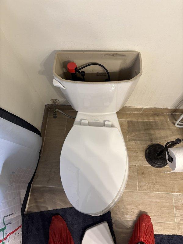 Responded to a service call for a loud squeaking noise during toilet flushing. Removed the tank lid and inspected the internal components, including the fill valve, flapper, flush lever, and refill tube, and identified the source of the noise as the fill valve assembly. Tested the flush cycle to confirm the noise was addressed and the tank refilled properly.
