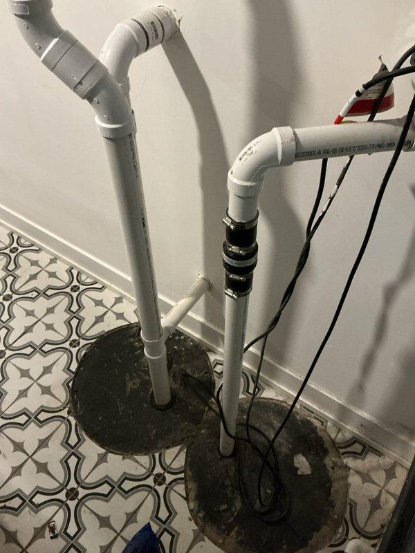 Performed an on-site evaluation of the existing dual sump pit installation, including the PVC discharge piping, rubber check valve couplings with clamps, and electrical cord routing, to provide an estimate for replacing the 2019-era sump pump. Documented the current condition of the pit lids and discharge lines, which showed light dirt and staining with no evidence of rust or frost, and confirmed that the surrounding newly installed flooring was unaffected.