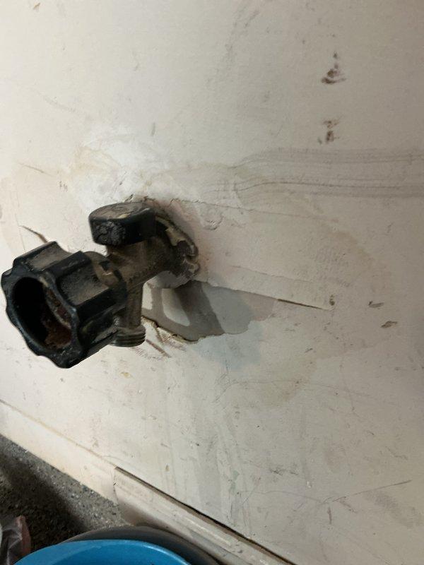Inspected the reported leak in the garage area, including the exterior hose bib, where staining and discoloration on the surrounding wall indicated prior moisture intrusion, and the water heater connections and supply piping, which showed no visible corrosion, rust, or active damage. Identified the main water shut-off at the water heater for isolation during repairs and documented conditions with photos. Findings were documented for the customer's review, and the work was left pending estimate approval and rescheduling.
