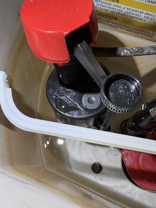 Performed routine maintenance flush on a wall-mounted Navien tankless water heater with no deficiencies found; the unit, supply piping, and venting showed no visible leaks, corrosion, or damage. Inspected the toilet tank and observed an aged fill valve assembly with mineral and sediment buildup, discolored water, and a partially lifted fill valve cap, indicating the need for further service. Customer is interested in establishing an annual maintenance schedule, with additional evaluation requested for the garbage disposal, cold-side water filter replacement, and ice maker.