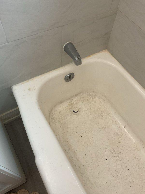 Diagnosed a restricted bathtub drain, with visible debris accumulation and staining at the drain and basin, consistent with grease, soap residue, and organic buildup in the drain line. Recommended and completed the repair to restore proper drainage and flow, and documented the pre-service condition of the tub with photos.