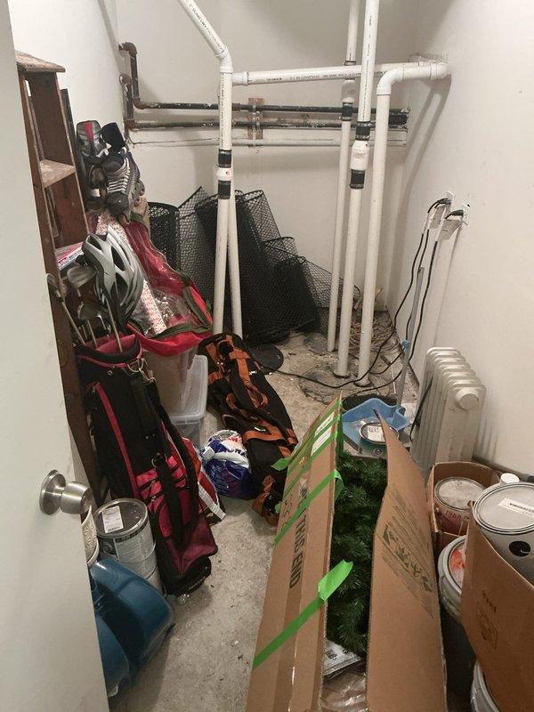 Responded to a report of water backing up from the floor drain beneath the water heater during showers and heavy rainfall, indicating a partial obstruction or restriction in the drain line. Inspected the utility closet and surrounding plumbing, confirmed no leaks or visible damage at the water heater or drain pan, and cleared the blockage to restore proper drainage flow.