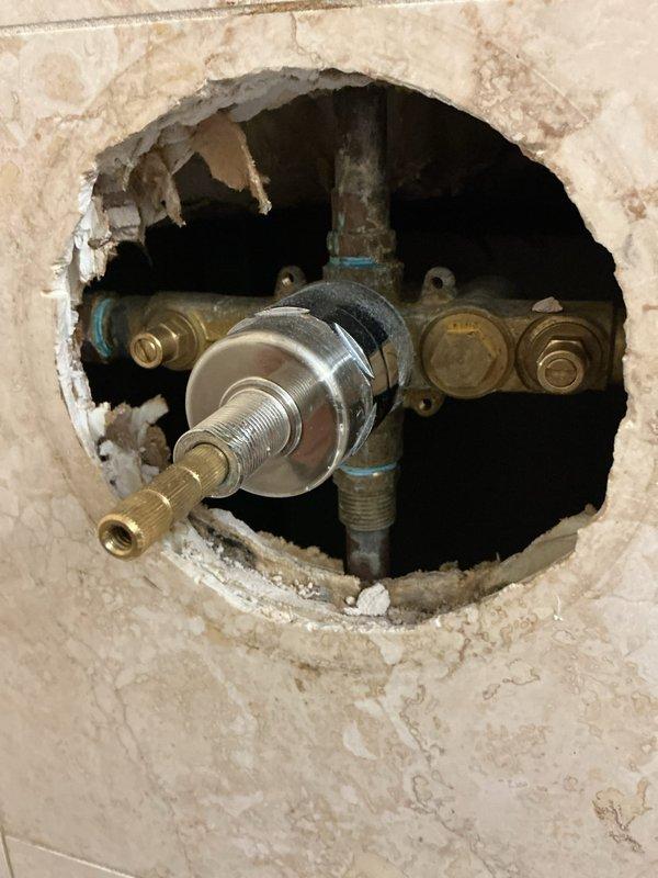 Diagnosed a leak occurring during toilet flush cycles and performed repairs to restore proper sealing and function. Inspected the toilet assembly and associated supply and drain connections, corrected the source of the leak, and tested through multiple flush cycles to confirm no further leakage. Photos taken of the adjacent tub and shower area, including an exposed shower valve access opening in the tile wall, to document existing conditions at the time of service.