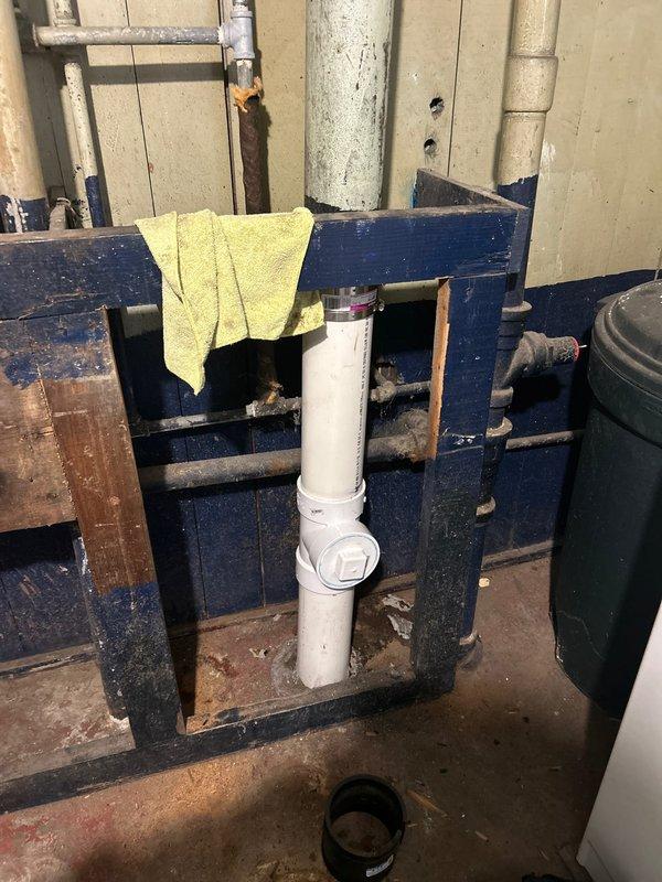 Performed water heater maintenance and flush, and inspected the repaired drain stack with a camera to evaluate a reported blockage. Observed the PVC drain stack with a wye fitting and cleanout plug connected to the existing metal pipe by a band coupling, and assessed the need for an additional cleanout for future access. Catch basin cleaning was evaluated, with an estimate to be provided prior to proceeding.