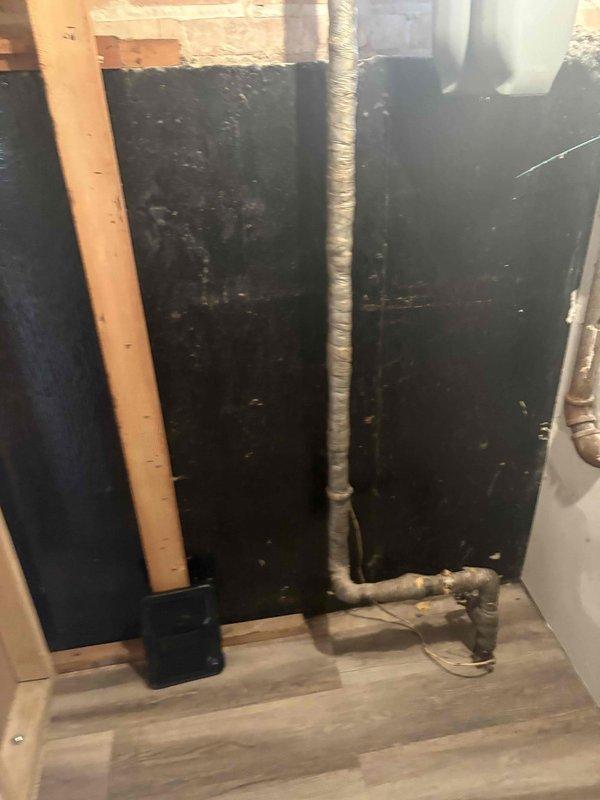Inspected the insulated supply lines in the basement and found a corroded section of wrapped piping with a degraded fitting and a worn, deteriorated foil-faced insulation wrap. Completed the sold repair by addressing the corroded section, replacing the failed fitting and valve components as needed, and re-wrapping the piping with new insulation to restore proper protection and system function.