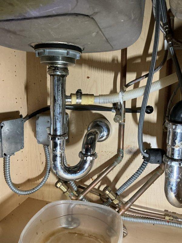 Inspected the kitchen sink drain assembly, P-trap, and disposal discharge line after the customer reported a clog that worsened when running the garbage disposal. Disassembled the P-trap and drain connections, cleared the accumulated debris and blockage, then reassembled all fittings and flushed the system to confirm proper drainage. Verified the disposal now runs freely with no backup and checked the connections under the sink for leaks.