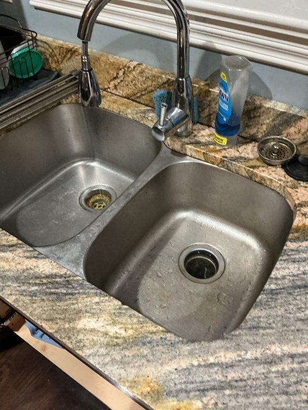 Inspected the kitchen sink drain assembly, P-trap, and disposal discharge line after the customer reported a clog that worsened when running the garbage disposal. Disassembled the P-trap and drain connections, cleared the accumulated debris and blockage, then reassembled all fittings and flushed the system to confirm proper drainage. Verified the disposal now runs freely with no backup and checked the connections under the sink for leaks.