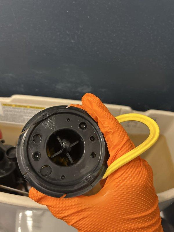 Inspected the loose toilet and accessed the tank interior to evaluate the internal components and mounting hardware. Retightened the fixture to secure it to the floor flange, and the bathroom was protected with floor covering and plastic sheeting throughout the work.