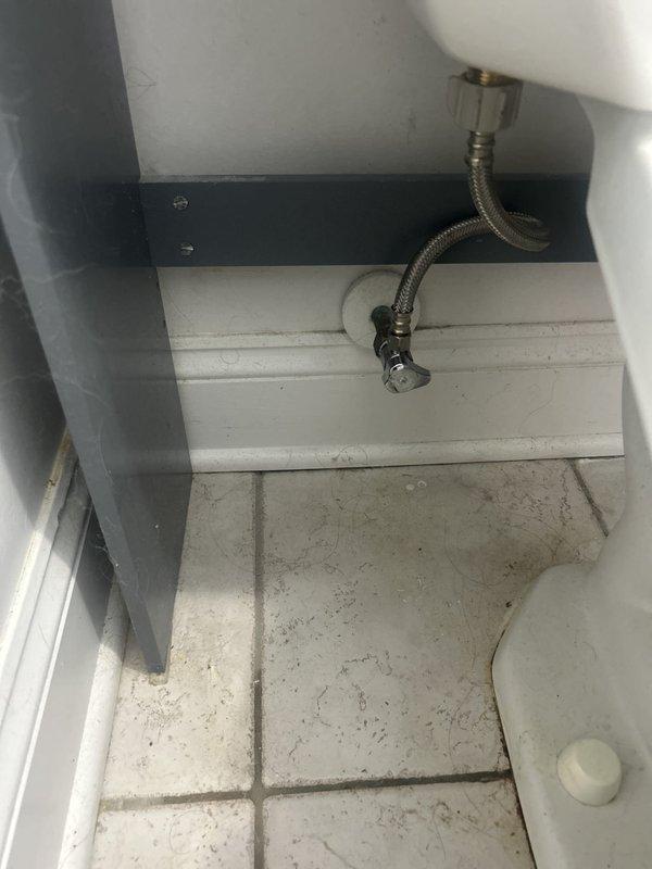 Diagnosed a toilet with a slow-refilling tank and inspected the fill valve assembly, flapper, flush linkage, and braided supply line, finding heavy rust and mineral buildup inside the tank. Serviced the fill valve and supply connection to restore normal tank refill and flush performance, and evaluated the bathroom's dedicated shutoff valve, which has a broken lever, for repair.
