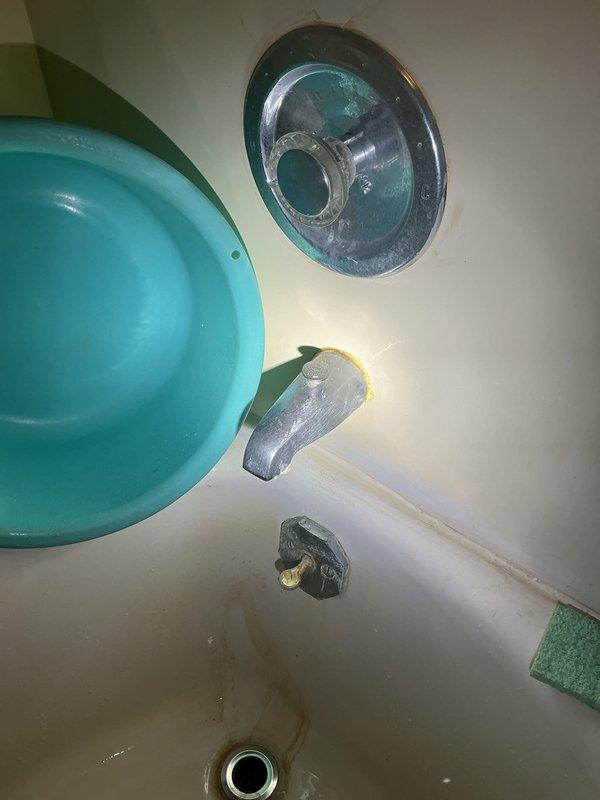 Replaced the corroded bathtub faucet trim, spout, and handle, removing the mineral-encrusted escutcheon and worn diverter components, then resealed the spout-to-wall joint with fresh caulk. Replaced the front and rear exterior hose bibs, removing the deteriorated brass fittings and rusted hose bib assemblies, installing new frost-resistant units, and sealing around the wall penetrations. Tested all fixtures for proper operation and leaks.