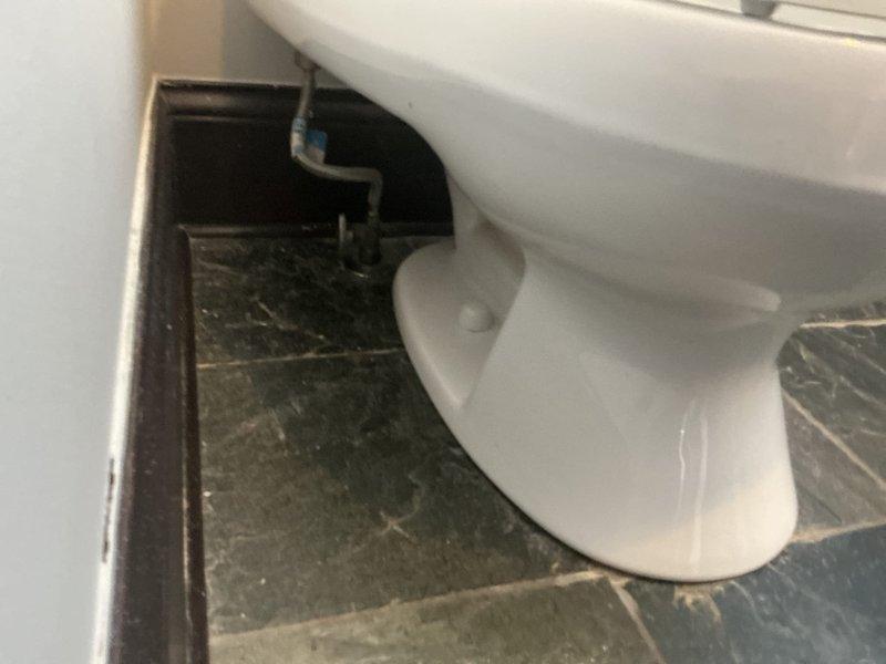 Installed a client-supplied, gravity-fed, two-bolt toilet over the existing flange on the slate tile floor, secured it with closet bolts, and connected it to the existing braided supply line and shutoff valve. Verified the connection was leak-free and operating properly, then hauled away the old toilet. Installation is covered by a 1-year warranty.