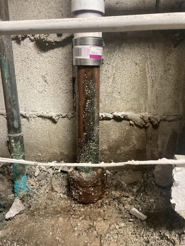 Replaced the corroded copper and cast iron drain stack sections in the basement with new PVC piping. Installed PROFLEX shielded couplings with stainless steel band clamps at the transitions to the existing drain line, restoring a secure, leak-free connection and eliminating the corrosion-related failure risk.