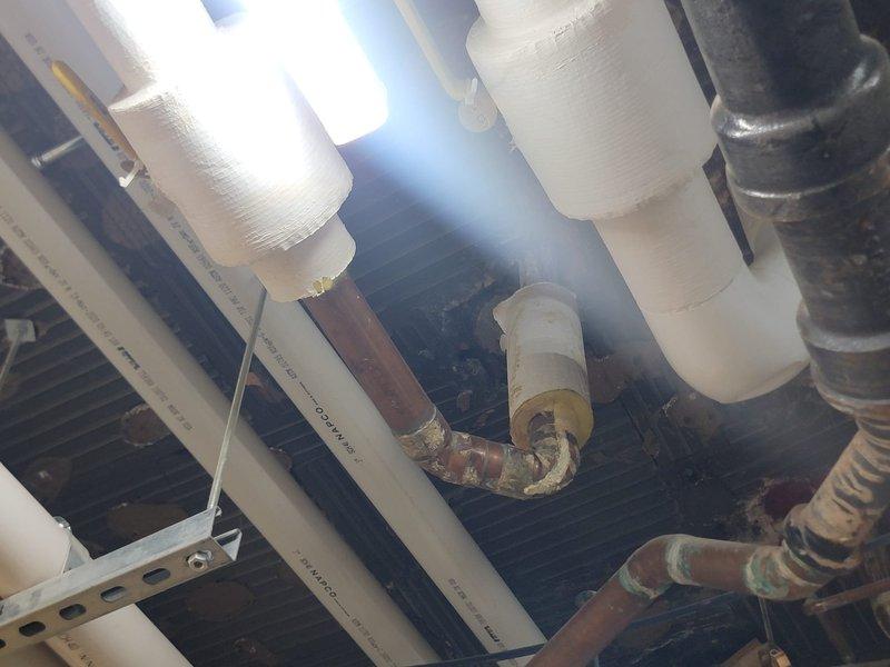 Responded to a backed-up kitchen sink drain connected to the grease trap and assessed the system for the blockage. Inspected the basement supply line and documented a leaking copper elbow with visible corrosion, mineral buildup, and degraded solder at the fittings, and recommended repair or replacement of the affected section.