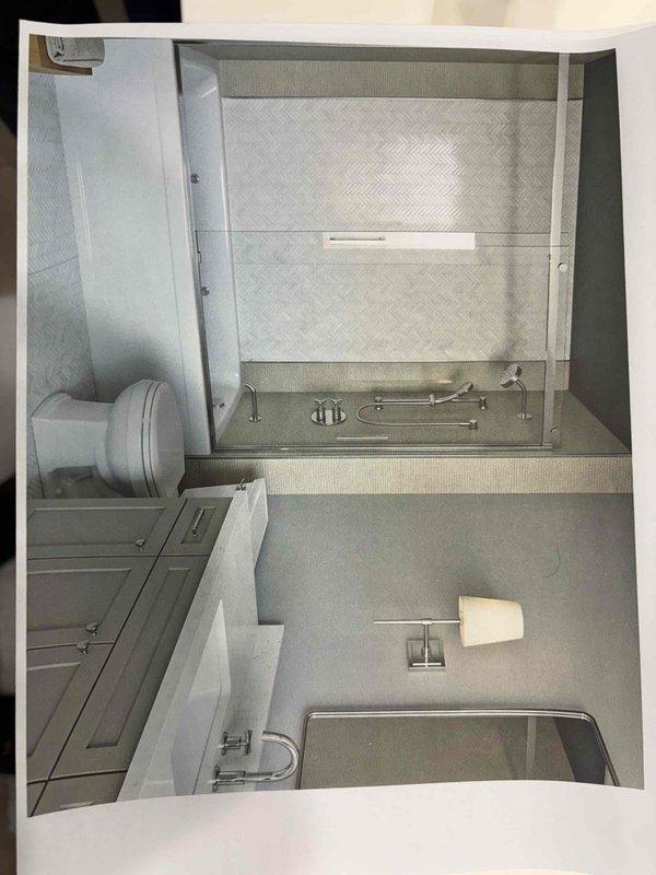 Performed an on-site plumbing estimate for the proposed remodel of the master and secondary bathrooms, including replacement of the tub and shower assemblies, two vanities, and associated faucets. Inspected and documented the existing alcove tub, which is in good condition with no visible cracks, rust, or staining, along with its deck-mounted lever handles, drain fitting, and supply fixtures. Reviewed the customer's design rendering, which specifies a tub-shower enclosure with a deck-mounted faucet, handheld shower on a slide bar, and a vanity with a widespread cross-handle faucet, and gathered the measurements and fixture details needed to prepare the quote.