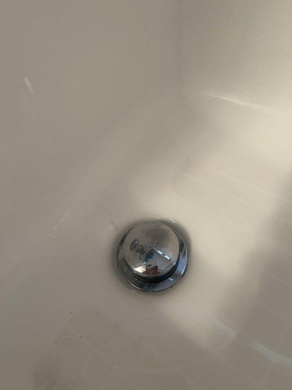 Repaired the tub faucet and cleared the tub drain line using a drain snake, restoring proper flow and operation. Inspected the pipe and shutoff valve to the exterior spigot and noted a black mold spot on the bathroom tile for the customer's attention. Drain stopper and basin were inspected post-service and found clean, with no visible damage, rust, or buildup around the drain.