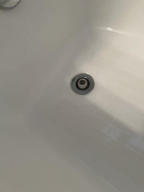Repaired the tub faucet and cleared the tub drain line using a drain snake, restoring proper flow and operation. Inspected the pipe and shutoff valve to the exterior spigot and noted a black mold spot on the bathroom tile for the customer's attention. Drain stopper and basin were inspected post-service and found clean, with no visible damage, rust, or buildup around the drain.